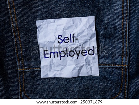 The inscription on the crumpled paper on jeans background. Self-Employed
