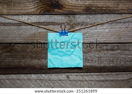 Instant photo and paper heart hanging on the clothesline without words on old wood background