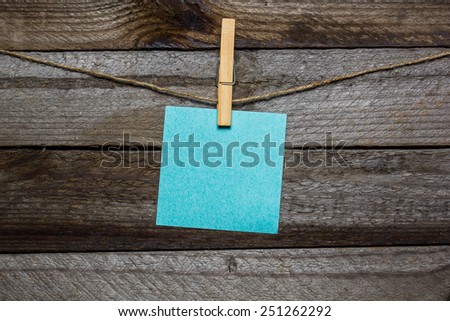 Instant photo and paper heart hanging on the clothesline without words on old wood background