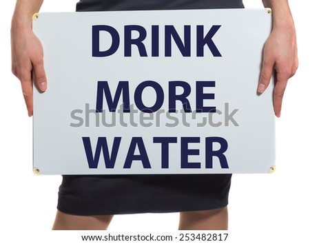 Businesswoman holding a card with a motivational message written on it Drink more water
