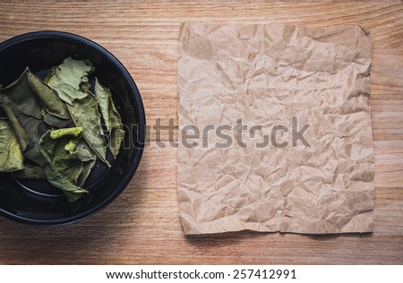 Spices for prepare tasty food with soft shadow in the wooden background with paper for taxt