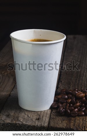 Coffee eco cup with package on the wooden vintage table and place for text