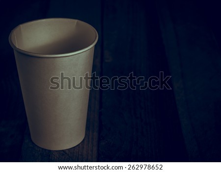 Coffee eco cup with package on the wooden vintage table and place for text