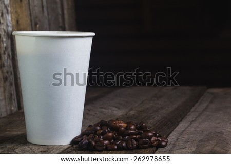 Coffee eco cup with package on the wooden vintage table and place for text