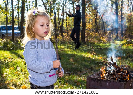 Family cook barbecue in the spring park