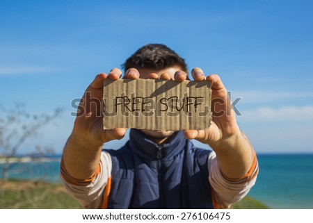 Guy holding a carton paper with text Free stuff