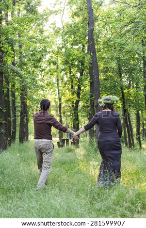 Lovers man and woman walking on the spring forest