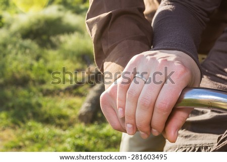 Lovers man and woman riding on a vintage bike and holding hands