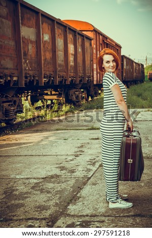 Beautiful girl walking on the railroad