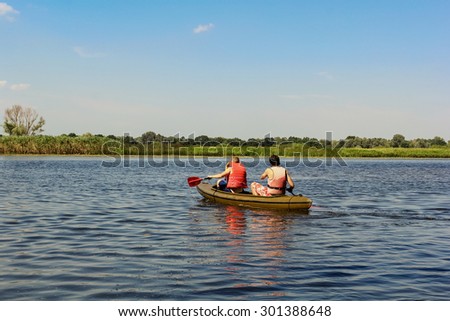 Athletes swim kayak riding canoe in river