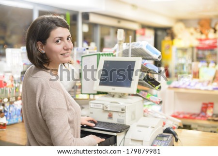 Young woman at cash register in a store