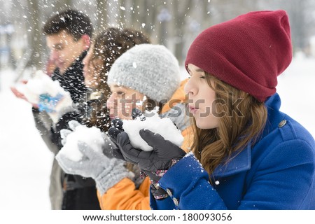 A group of young people playing in the snow