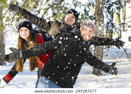 A group of young people playing in the snow