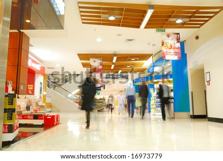 people\'s motion in busy shopping mall