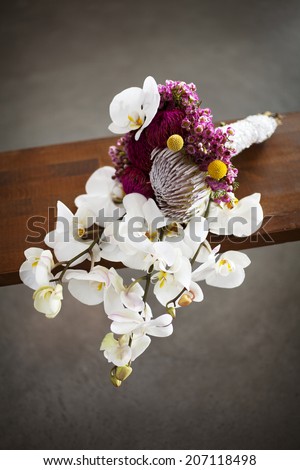 Wedding bouquet on the wooden table. Grey background.