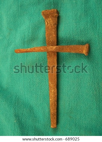 Nails in Shape of Cross on green background