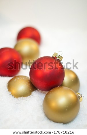 Arrangement of Red and Gold Ornaments on Snow allows space for copy.