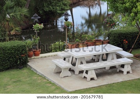White stone table and chair in the garden of country house