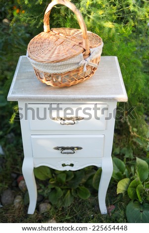 Wicker picnic basket with checkered red and white table cloth