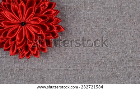 red flower handmade fabric on a background of natural linen