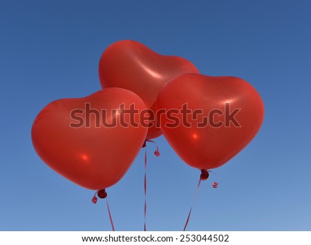 The balloon. Heart red on a blue sky.
