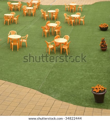 Tables and beautiful chairs in empty open air cafe
