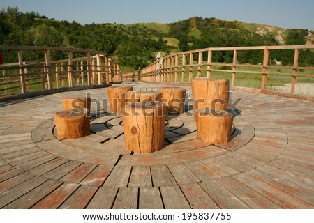 picnic area, wooden chairs and table,Nirano mud volcano, Italy