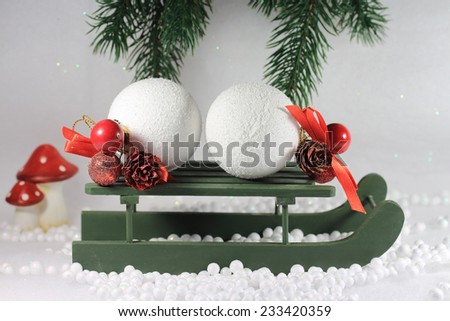 Snow balls on a wooden sleigh, in the snow.