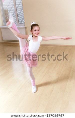 happy small ballerina at dancing school