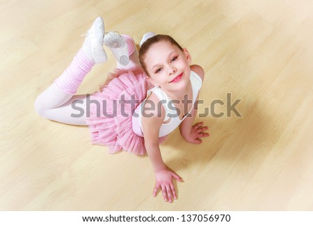 happy small ballerina at dancing school