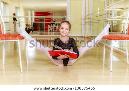 small dancer on a chair with dancing school