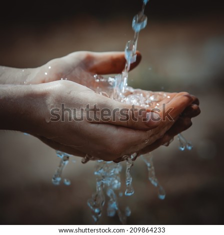 Woman\'s dirty hands with water splash