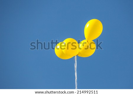 yellow balloons in the sky