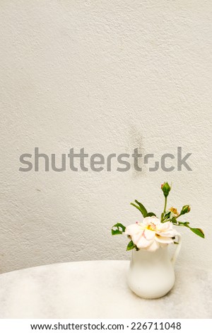 Dirty on the wall with decorated flower vase