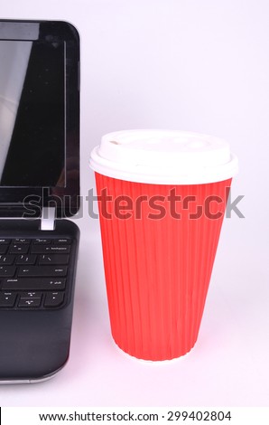 Red Take Away Coffee Cup with Laptop Computer