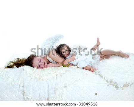 Sleeping angel with one year old girl on white mattress isolated on white