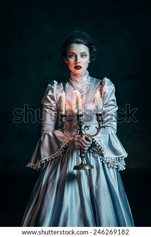 Woman in victorian dress imprisoned in a dungeon