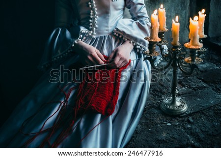 Woman in victorian dress imprisoned in a dungeon