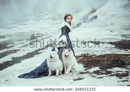 The woman in blue coat walk with a dog