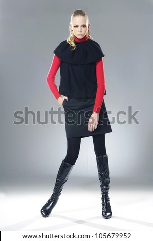 Full body fashion model in modern clothes posing in the studio