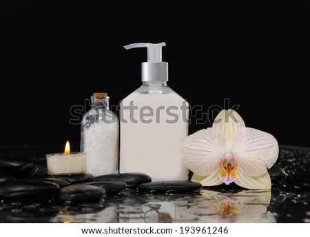 Still life with orchid, massage oil, candle and , zen stones,