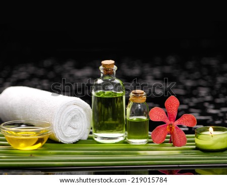 spa concept Ã¢Â?Â?orchid and ,stones , green leaf. candle, massage oil