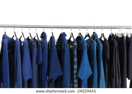 A row of designer fashion clothing hanging on hangers