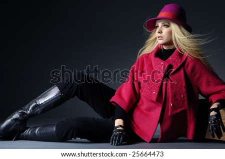 fashion model sitting at black background