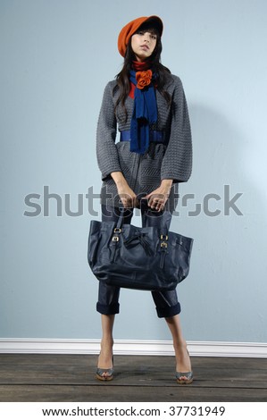 Fashion portrait of young lady with bag