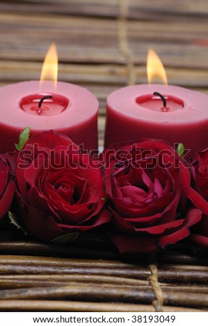 Red rose and candles isolated on mat