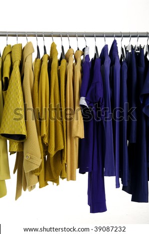 A row of fashion clothing hanging on hangers