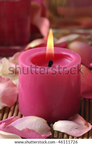 Red Candle and red Roses petals