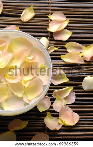 bowl of rose petals on bamboo stick straw mat