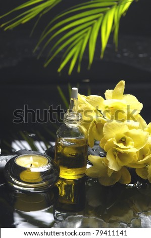 essential oil and orchid with candle for aromatherapy